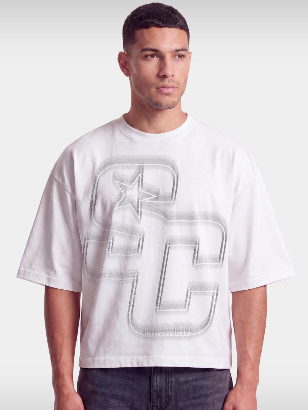 Monaco Club white boxy tee worn by model, front view with tonal grey SC monogram and star.