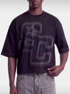 Black Club boxy tee on model, front view with tonal black SC varsity monogram and star.