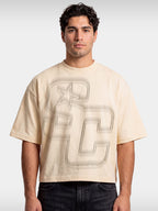Monaco Club ivory boxy tee worn by model, front view with sprayed SC monogram graphic.
