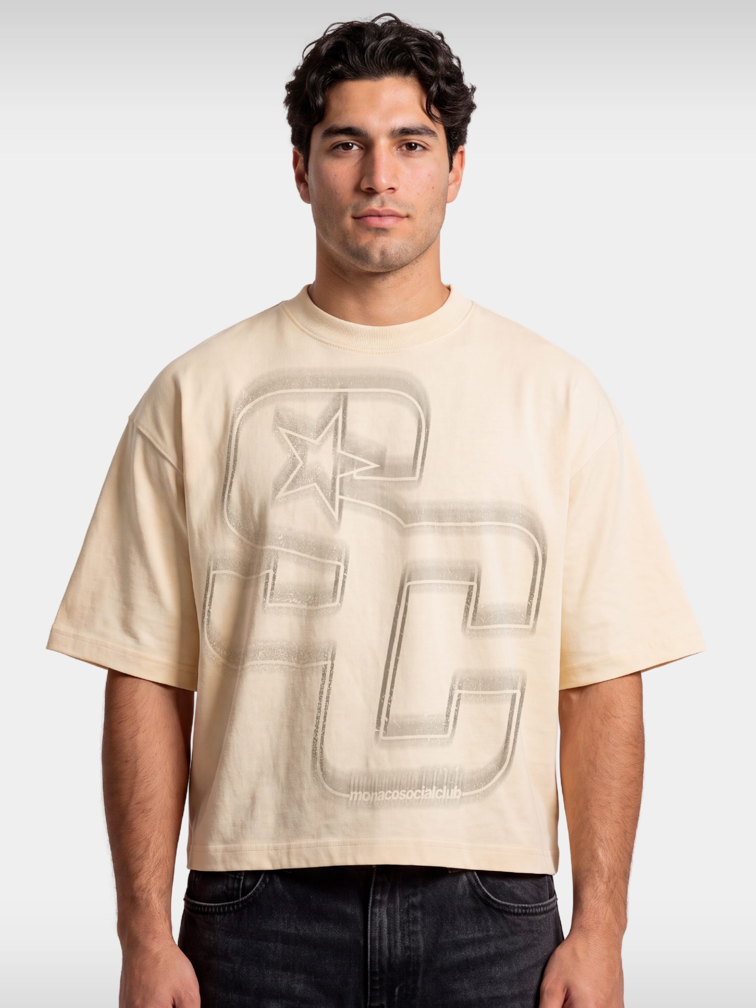Monaco Club ivory boxy tee worn by model, front view with sprayed SC monogram graphic.