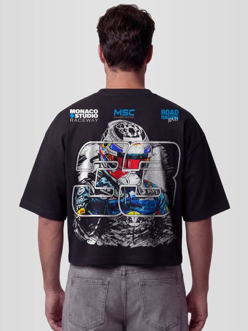 Model wearing the #33 Racing Series Heavyweight Boxy Tee in Black with full-color sketched racing driver portrait and MSC Championship badges — Monaco Social Club streetwear