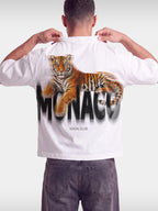 Monaco Tiger white boxy tee worn by model, back view with reclining tiger over blurred wordmark.