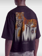 Black Tiger boxy tee on model, angled back view with tiger graphic and white Monaco lettering.