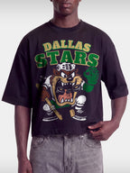Black Dallas Stars Taz boxy tee on model, front view with green and gold arched team lettering.
