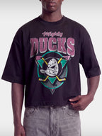 Black Mighty Ducks vintage boxy tee on model, front view with pink lettering and teal logo.