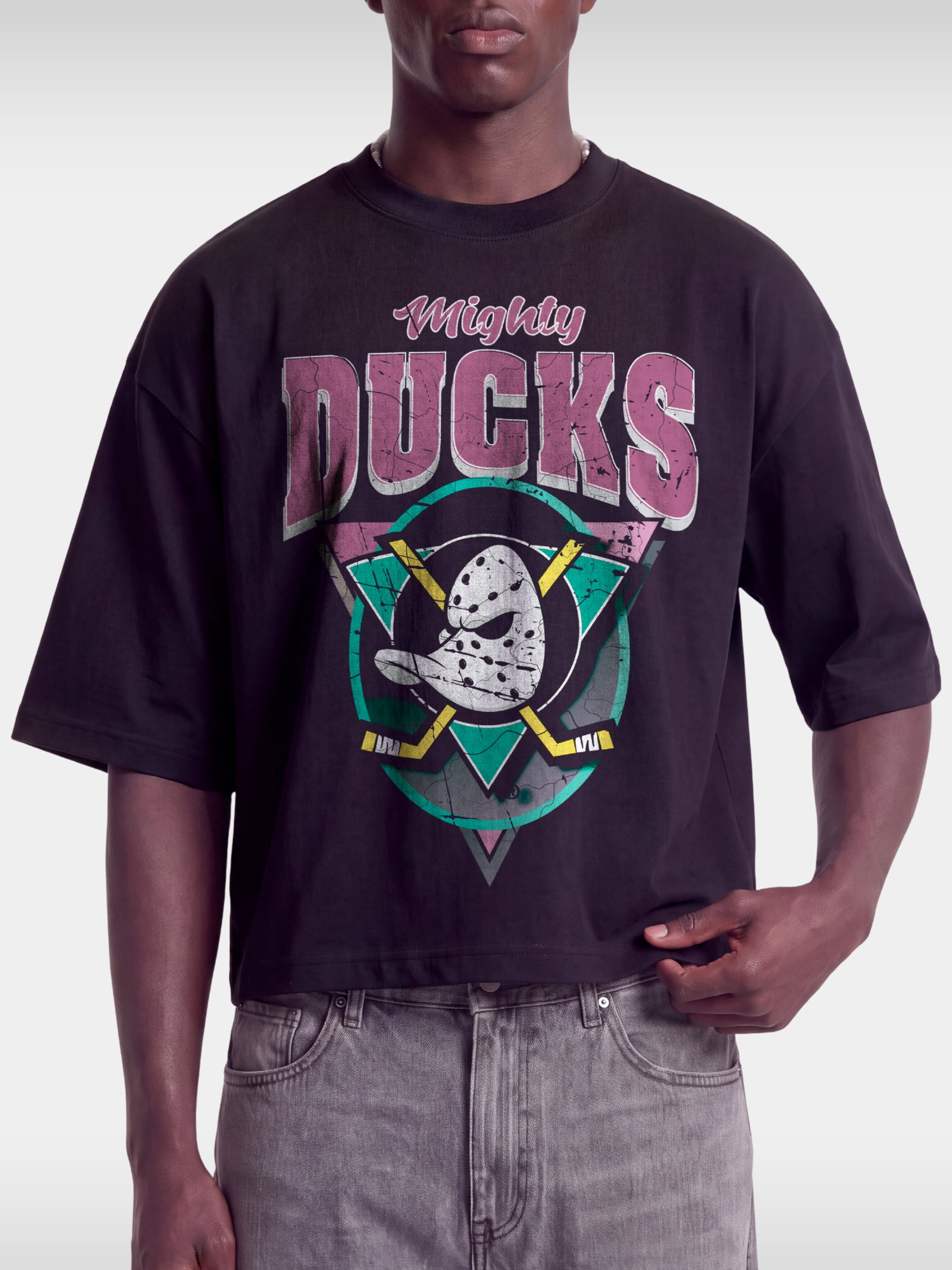 Black Mighty Ducks vintage boxy tee on model, front view with pink lettering and teal logo.