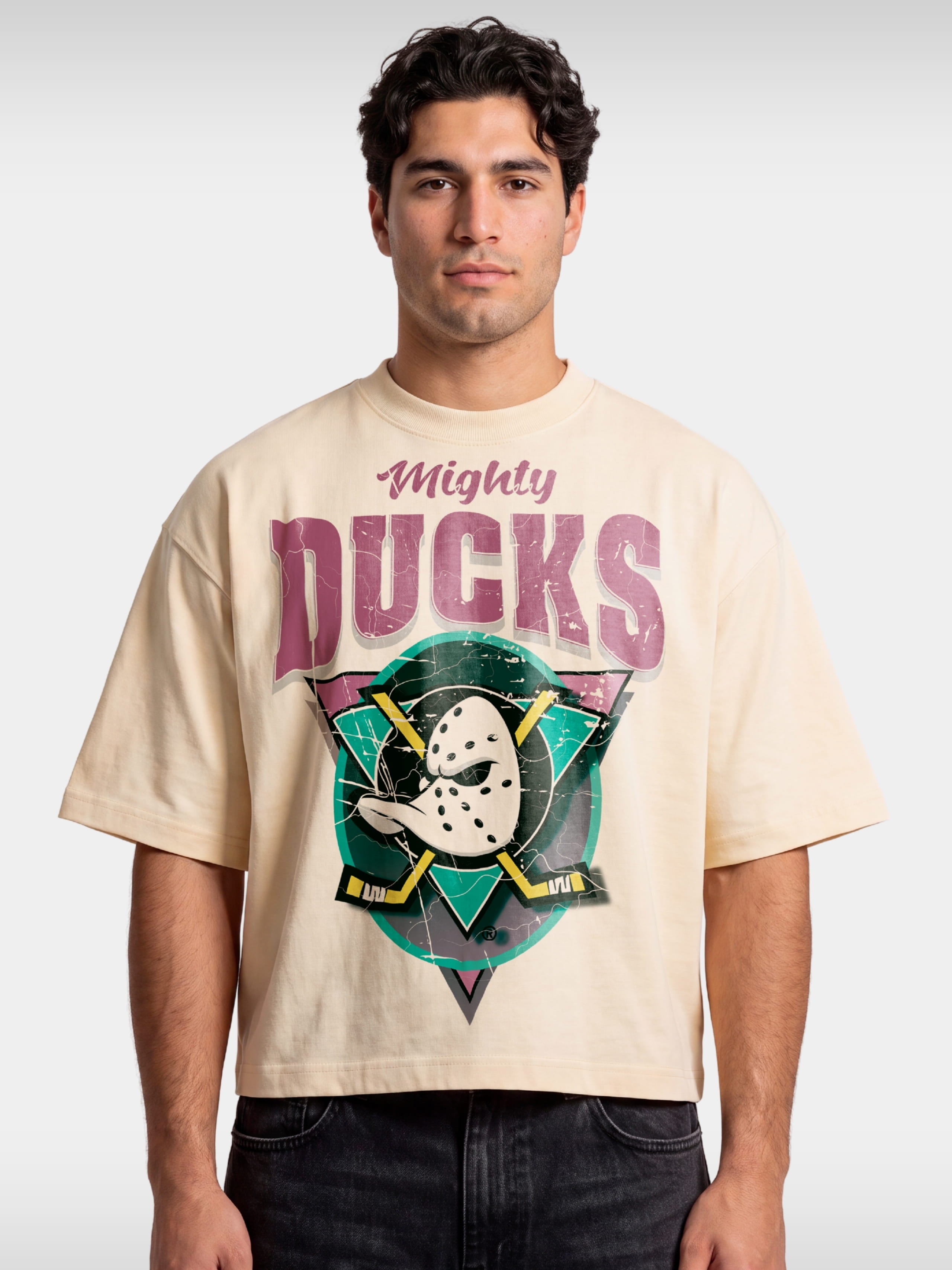 Ivory Anaheim Mighty Ducks boxy tee worn by model, front view with retro duck mask logo.