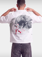 White No. 6 Next Chapter boxy tee worn by model, back view with football helmet photo print.