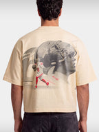 Ivory No. 6 Next Chapter boxy tee worn by model, back view with football player photo print.