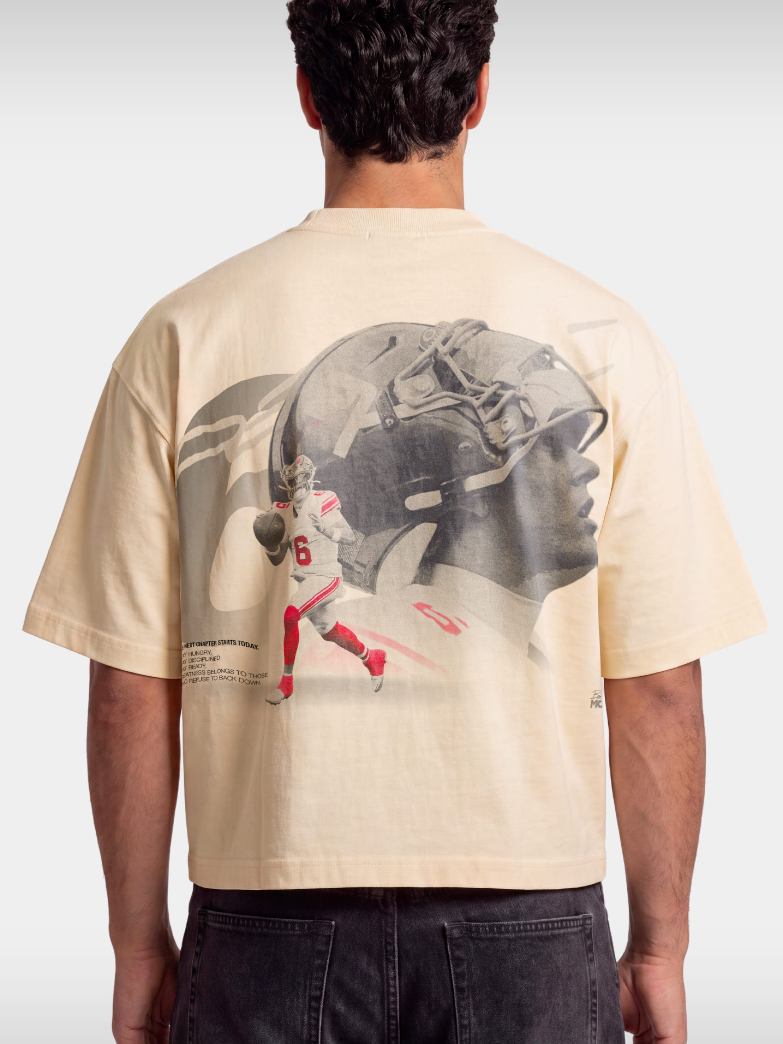 Ivory No. 6 Next Chapter boxy tee worn by model, back view with football player photo print.