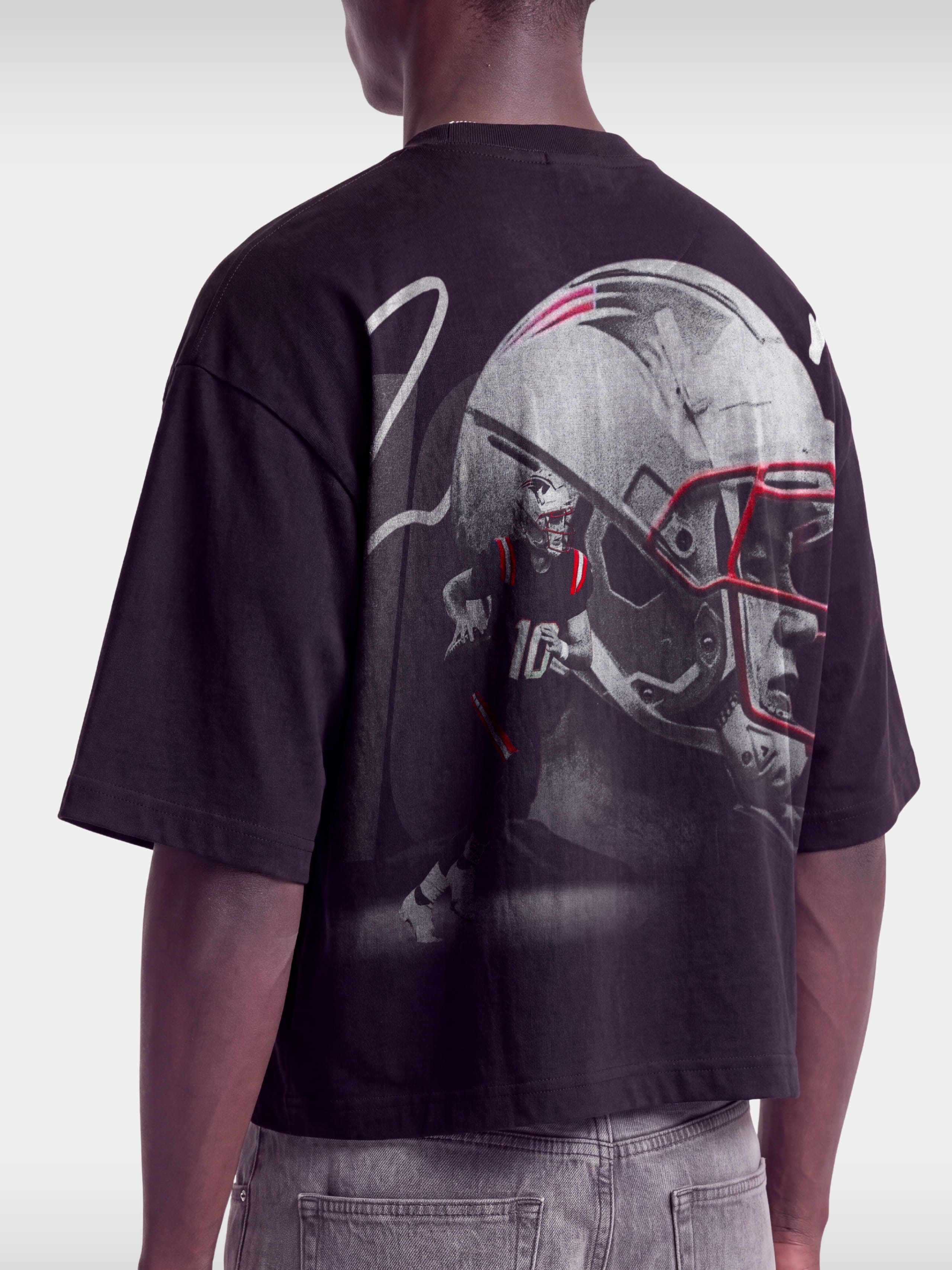 Black No. 10 Franchise boxy tee by Monaco, back view showing helmet and quarterback print detail.