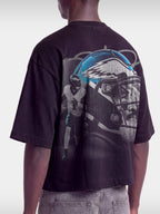 Monaco No. 1 Flight boxy tee in black, worn by model, angled view with teal winged helmet and quarterback graphic.