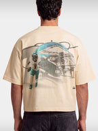 Ivory No. 1 Flight boxy tee worn by model, back view with faded helmet and quarterback graphic.