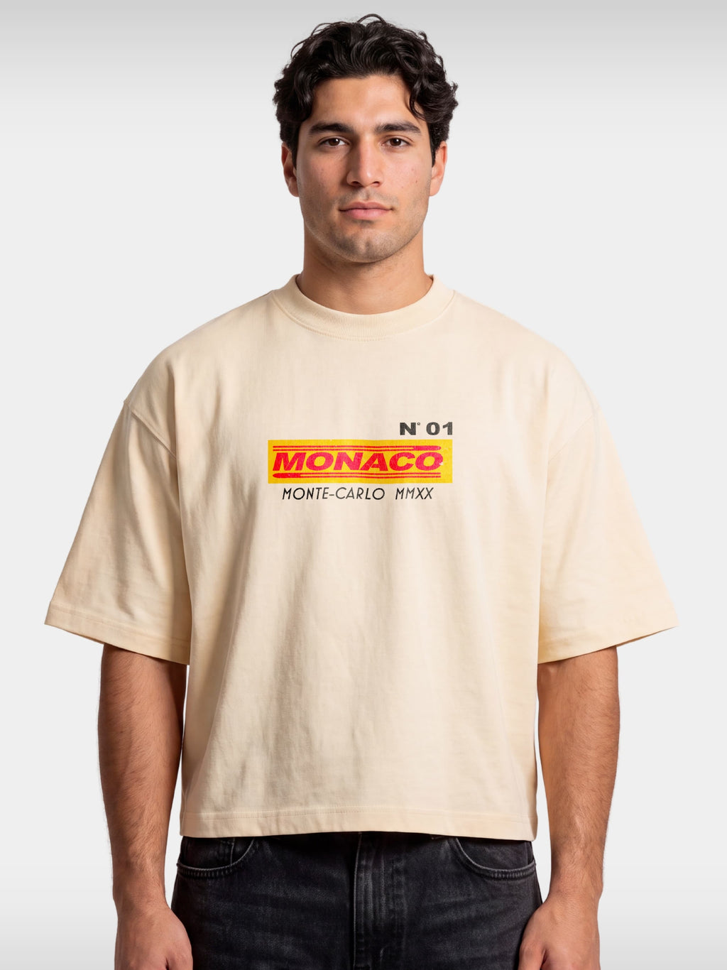 Ivory Trackside boxy tee worn by model, front view with small MONACO Monte-Carlo chest logo.
