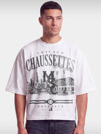 Monaco Chaussettes white boxy tee worn by model, front view with Chicago skyline baseball print.