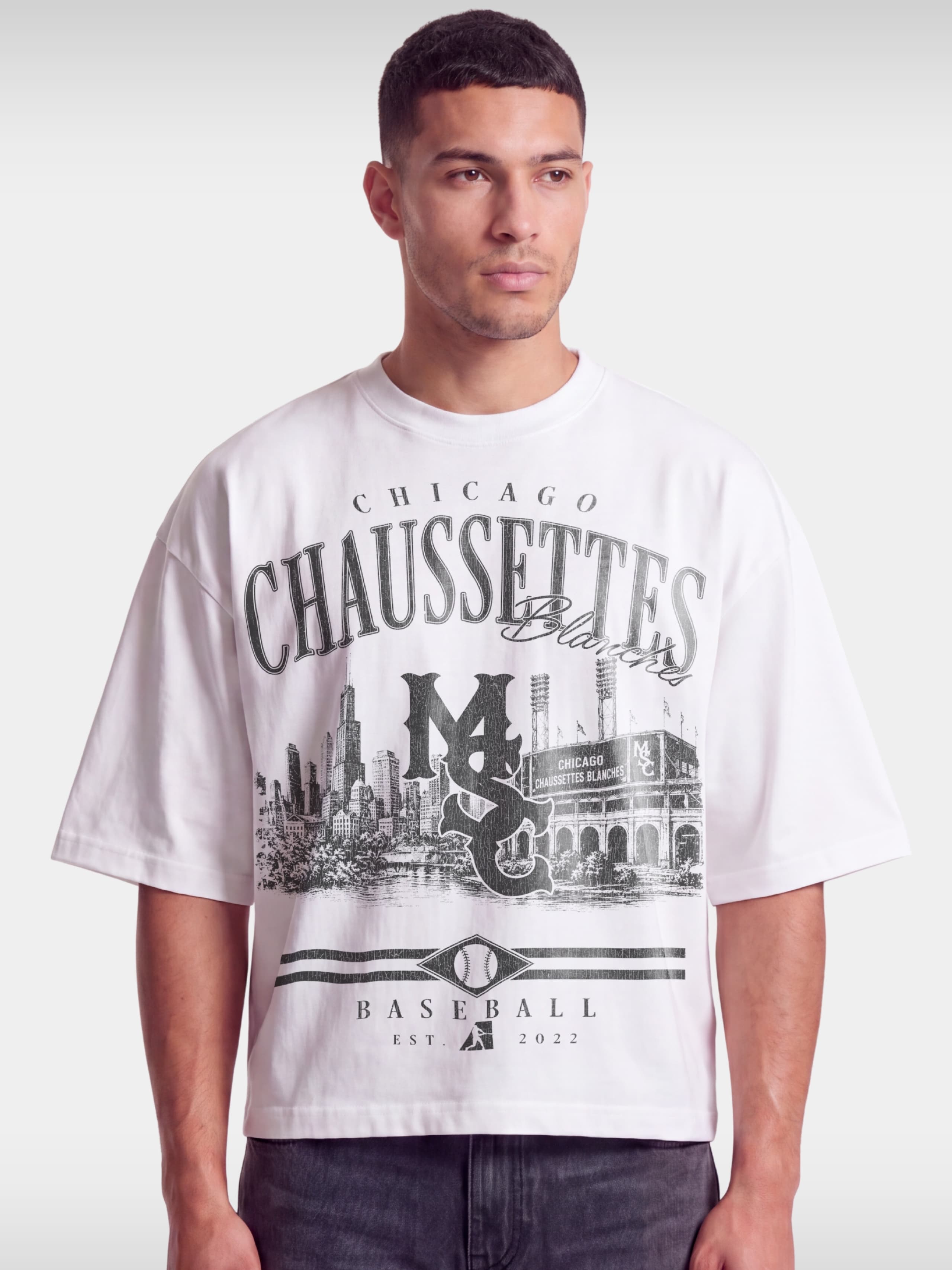 Monaco Chaussettes white boxy tee worn by model, front view with Chicago skyline baseball print.