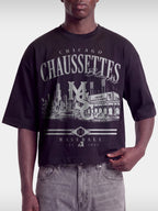 Black Chaussettes boxy tee on model, front view with faded Chicago stadium and MSC monogram.