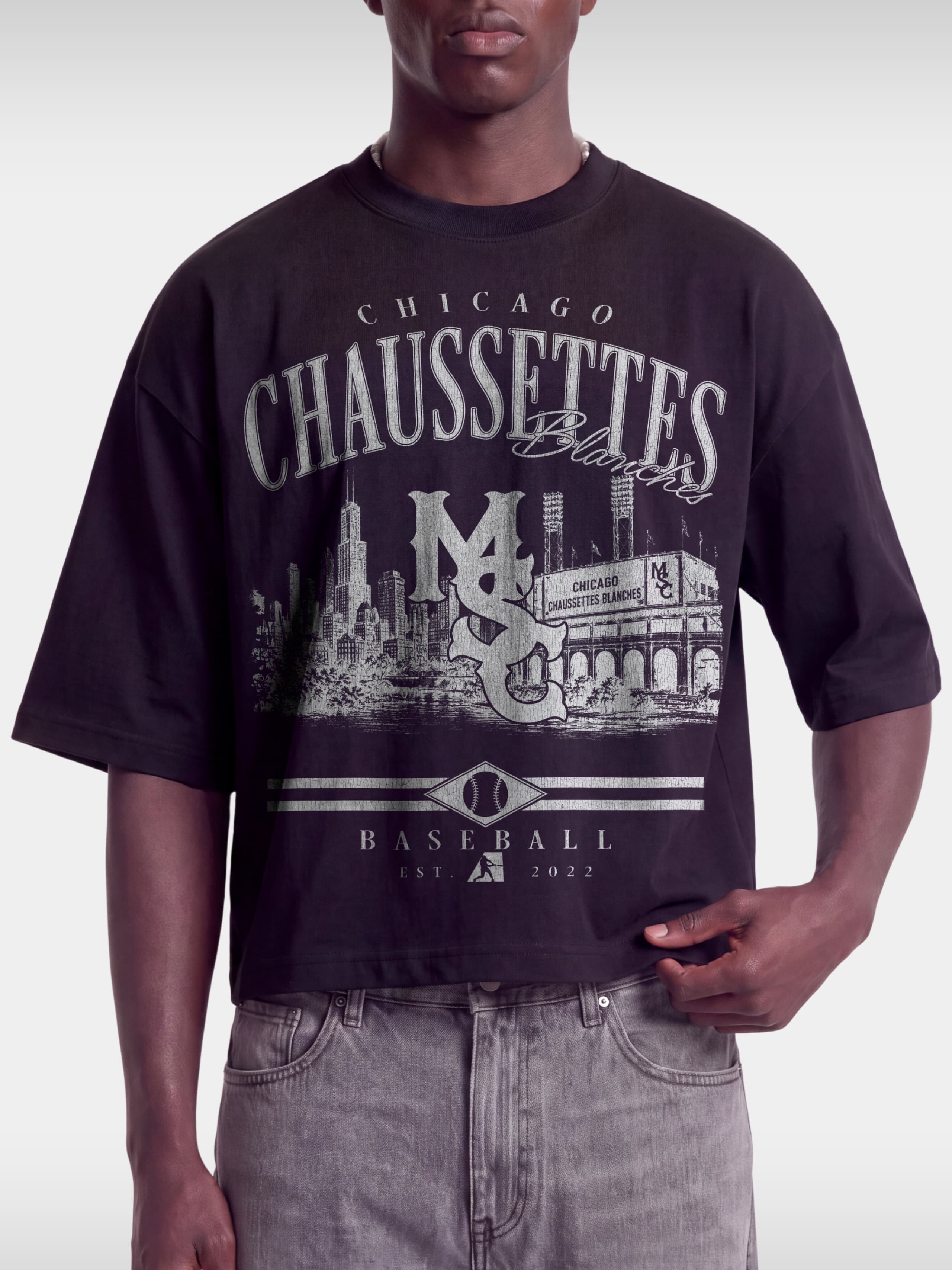 Black Chaussettes boxy tee on model, front view with faded Chicago stadium and MSC monogram.
