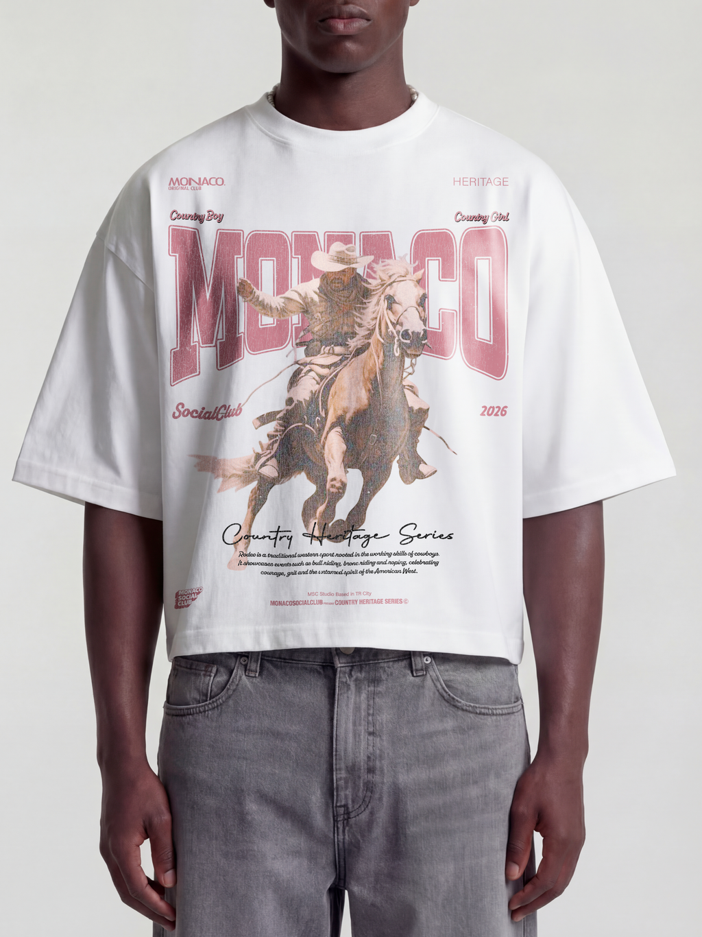 Man model wearing the Country Heritage Series Heavyweight Boxy Tee in White with western cowboy horseback graphic — Monaco Social Club streetwear