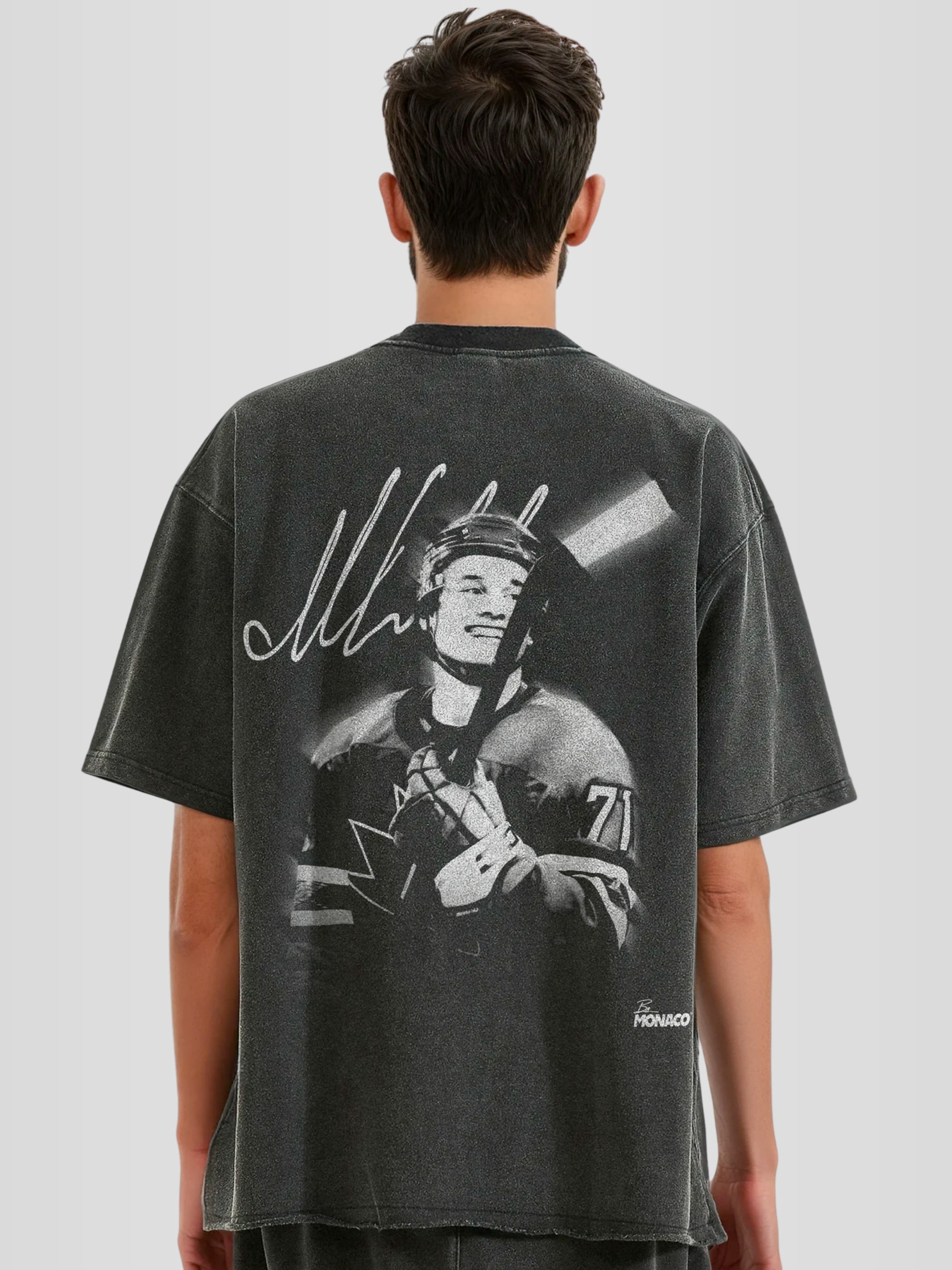 Man model wearing the Celebrini Legacy Blur Heavyweight Raw Hem Tee with motion blur hockey graphic — Monaco Social Club streetwear
