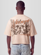 Man model wearing the Fearless Heavyweight Boxy Tee with skull-butterfly roses graphic and Monaco script — Monaco Social Club streetwear