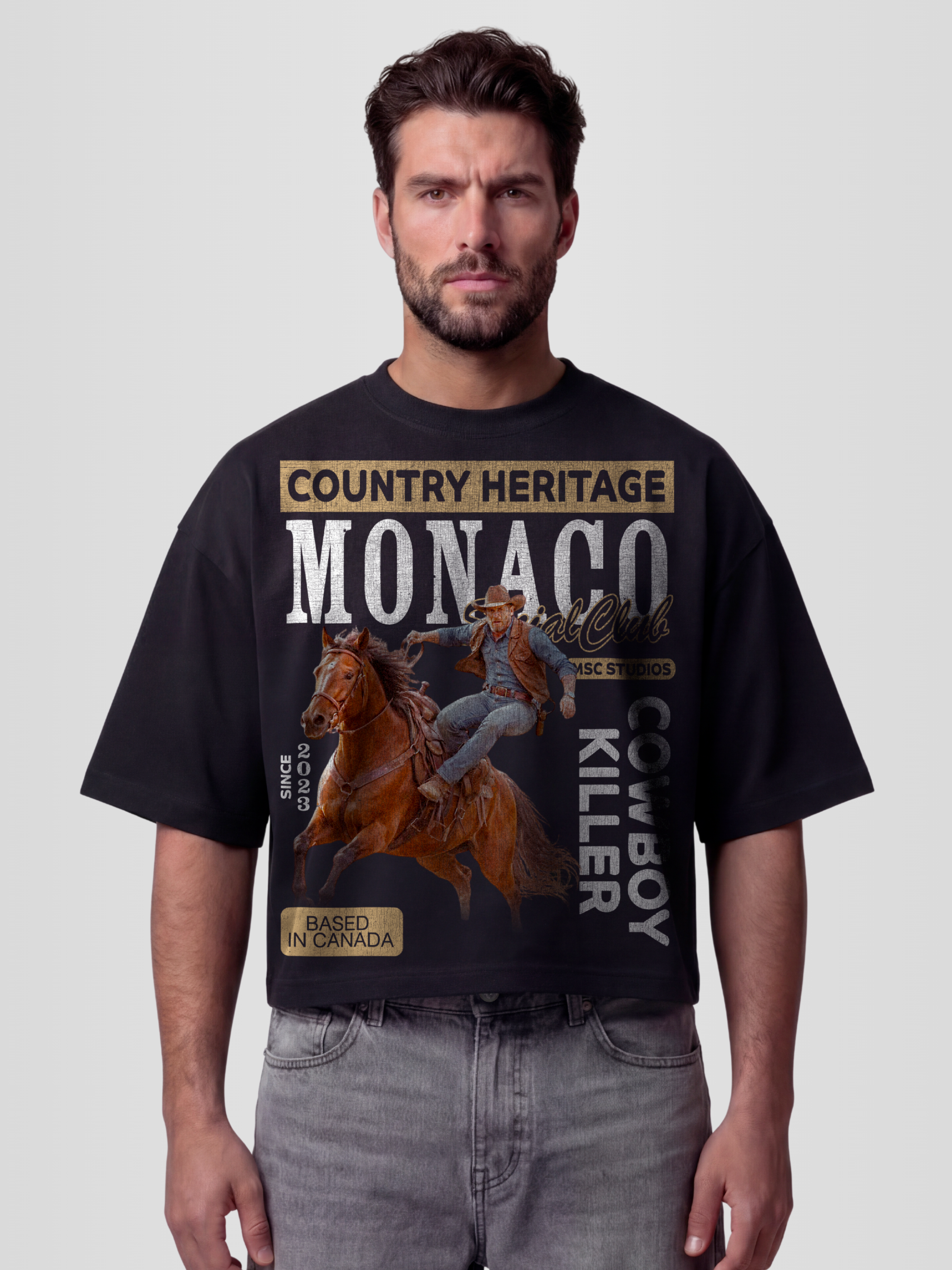 Man model wearing the Vintage Cowboy Heavyweight Boxy Tee in Faded Black with western horseback rider and Cowboy Killer graphic — Monaco Social Club streetwear