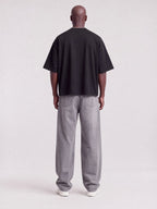 Monaco black boxy tee worn by model, full-length back view showing boxy fit and drop shoulders.