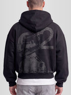 Model wearing the Racer No. 12 Heavyweight Full-Zip Hoodie in Faded Black with teal racing driver graphic — Monaco Social Club