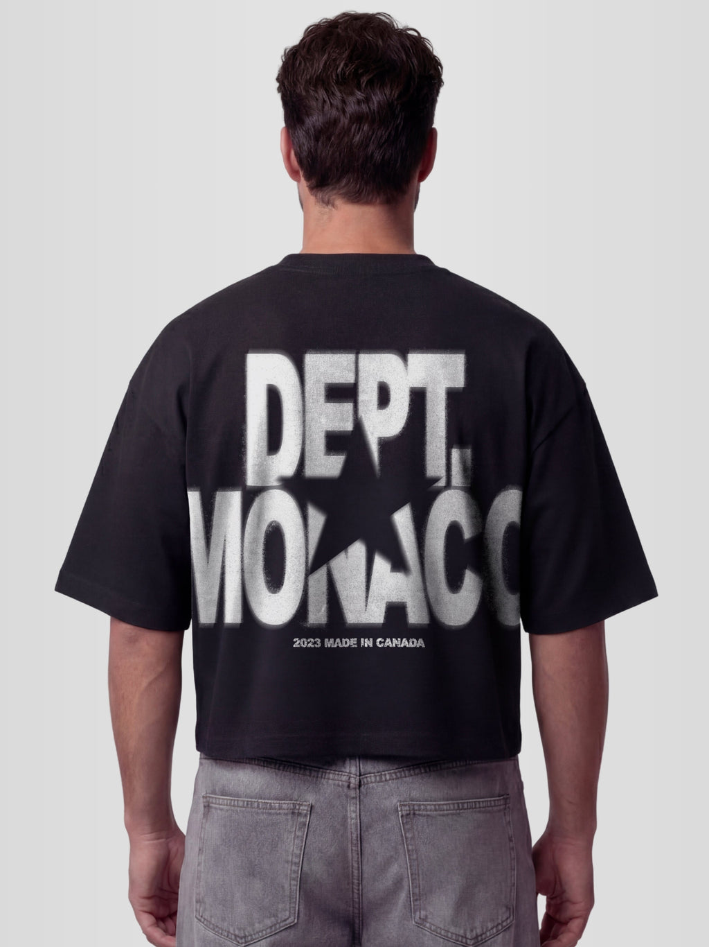Man model wearing the Blur Dept. Heavyweight boxy tee in Black with stacked Monaco typography and star graphic — Monaco Social Club streetwear