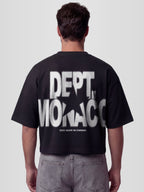 Man model wearing the Blur Dept. Heavyweight boxy tee in Black with stacked Monaco typography and star graphic — Monaco Social Club streetwear