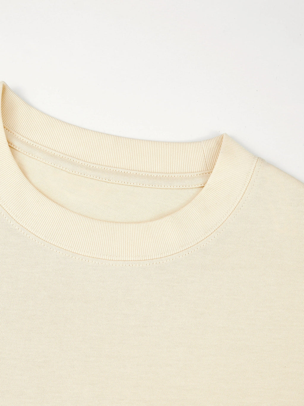 Ribbed crewneck collar detail on the ivory Monaco heavyweight cotton boxy tee.