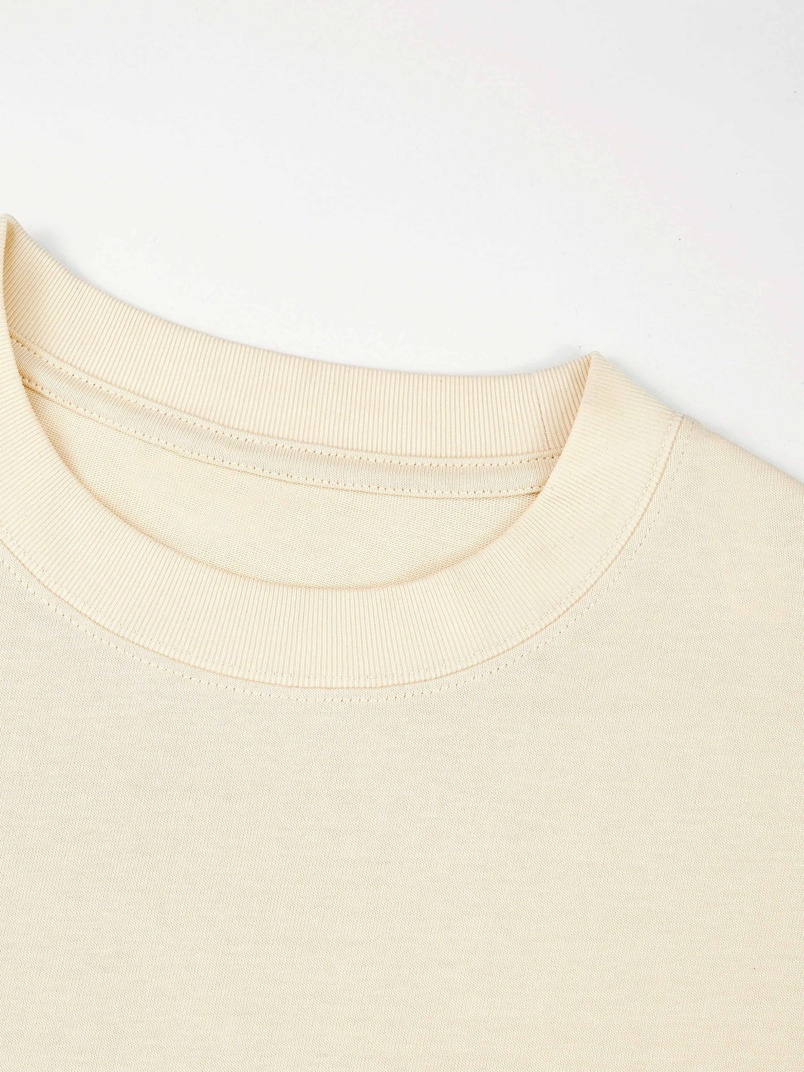 Ribbed crewneck collar detail on the ivory Monaco heavyweight cotton boxy tee.