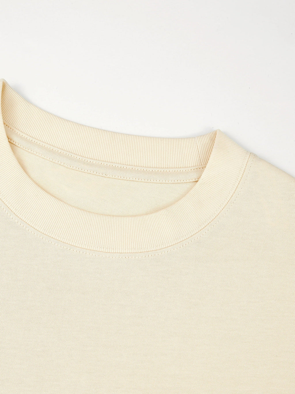Ribbed crewneck collar detail on the ivory Monaco heavyweight cotton boxy tee.