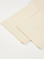 Monaco ivory boxy tee detail: folded sleeve, hem stitching and side seam.