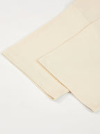 Monaco ivory boxy tee detail: folded sleeve, hem stitching and side seam.