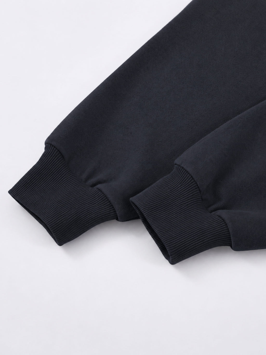 Black Monaco athleisure hoodie sleeve detail showing long sleeves with wide ribbed cuffs.