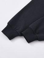 Black Monaco athleisure hoodie sleeve detail showing long sleeves with wide ribbed cuffs.