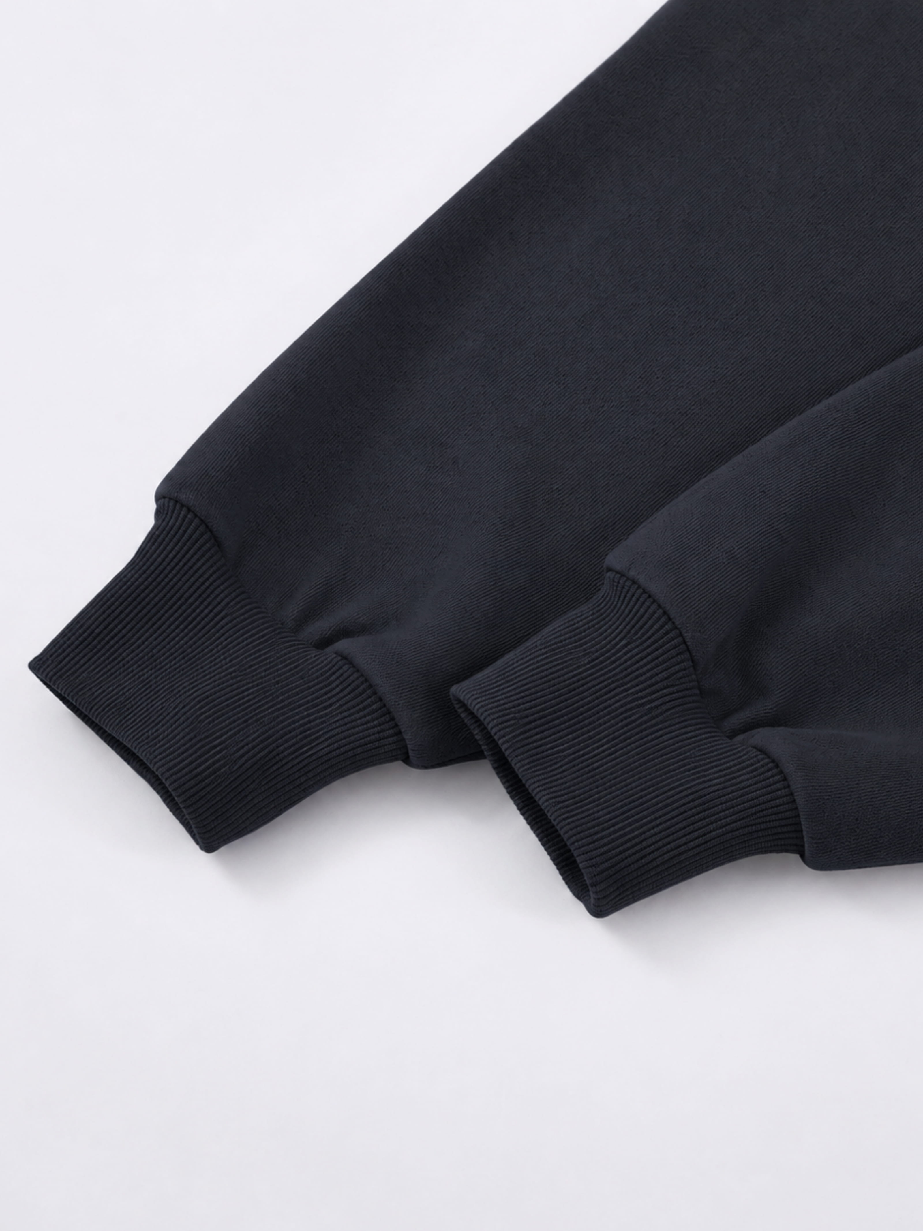 Black Monaco athleisure hoodie sleeve detail showing long sleeves with wide ribbed cuffs.