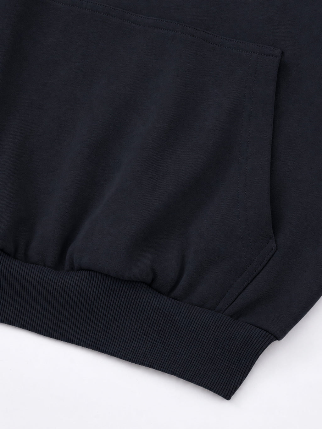 Black Monaco athleisure hoodie detail showing kangaroo pocket stitching and ribbed waistband.