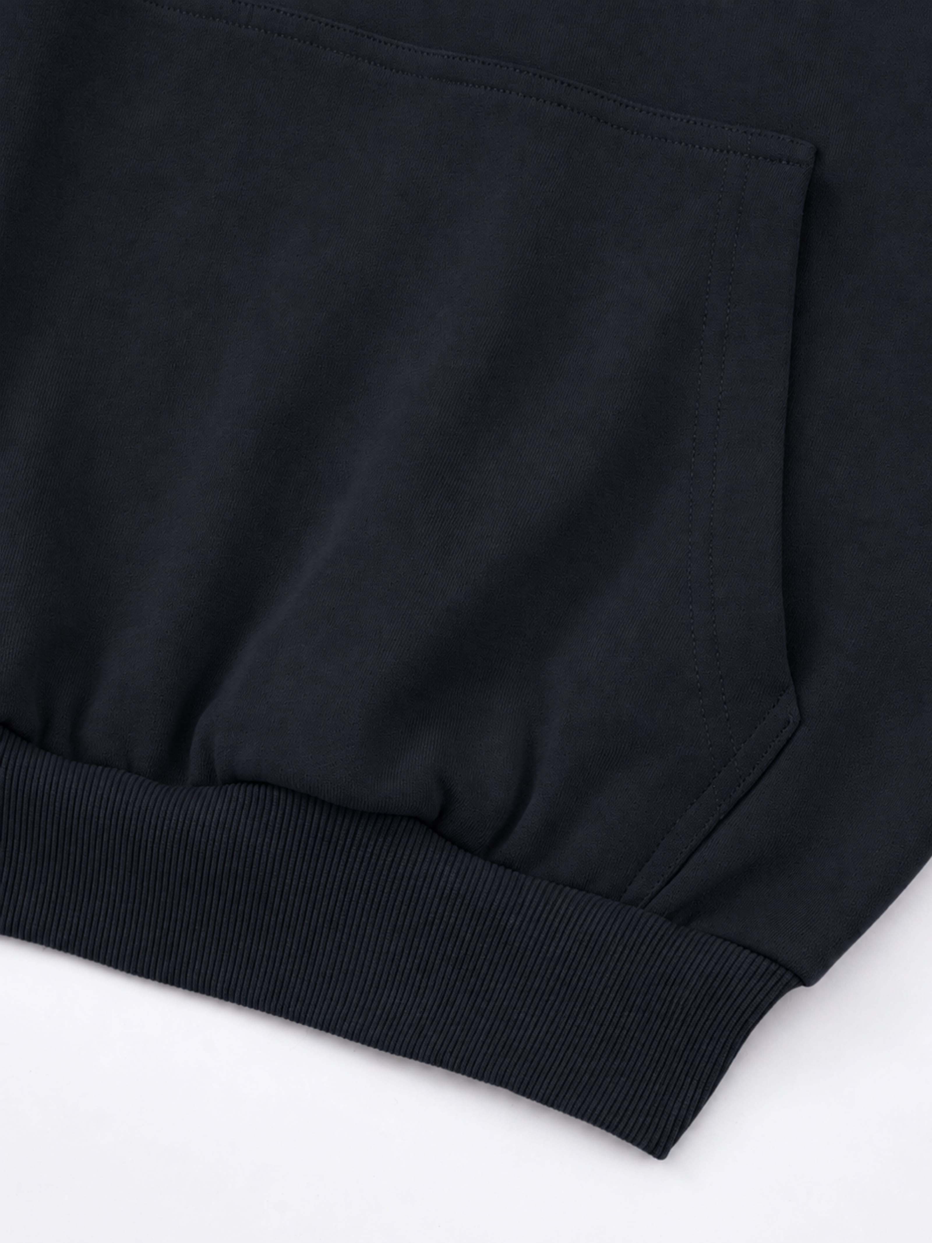 Black Monaco athleisure hoodie detail showing kangaroo pocket stitching and ribbed waistband.