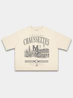Ivory Monaco Chaussettes boxy tee, front view with arched lettering and baseball diamond crest.