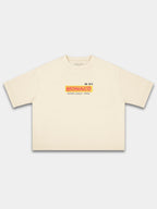 Monaco Trackside ivory boxy tee, front view with red and yellow racing logo on chest.