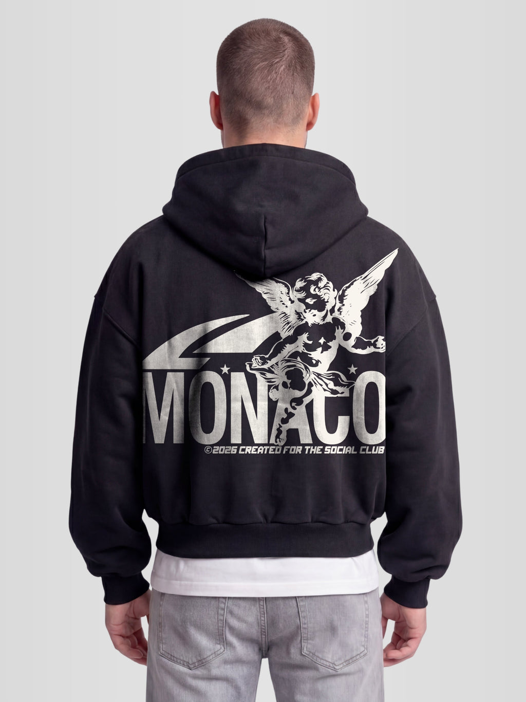 Man model wearing The saint double zip hoodie. Heavyweight Full-Zip Hoodie in black with back graphic — Monaco Social Club streetwear