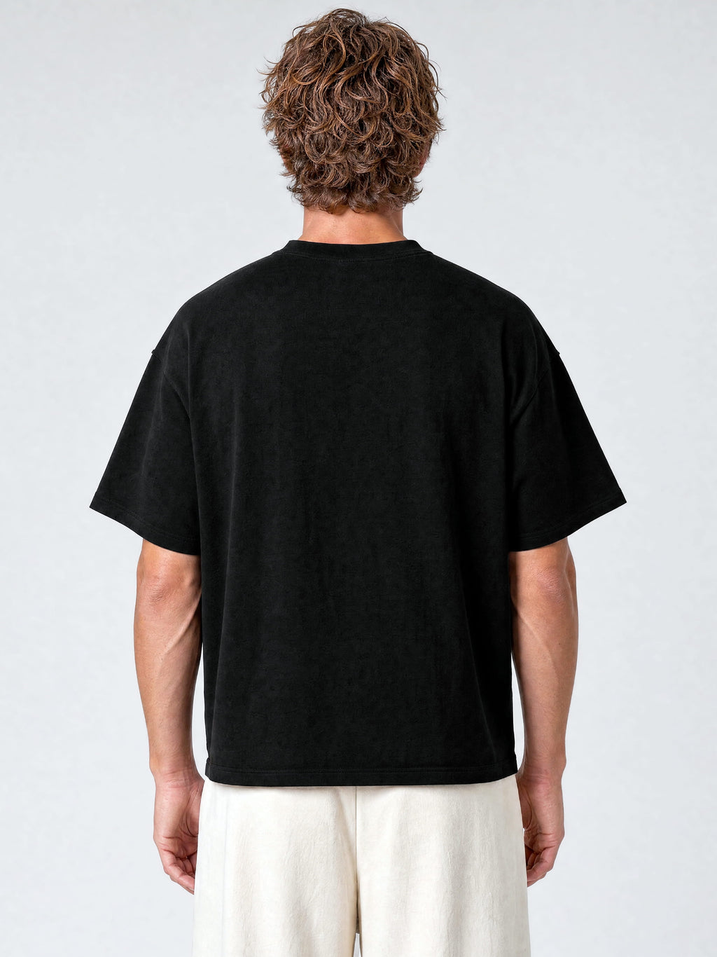 Black Monaco paneled shirt worn by model, back view showing oversized cut and drop shoulders.