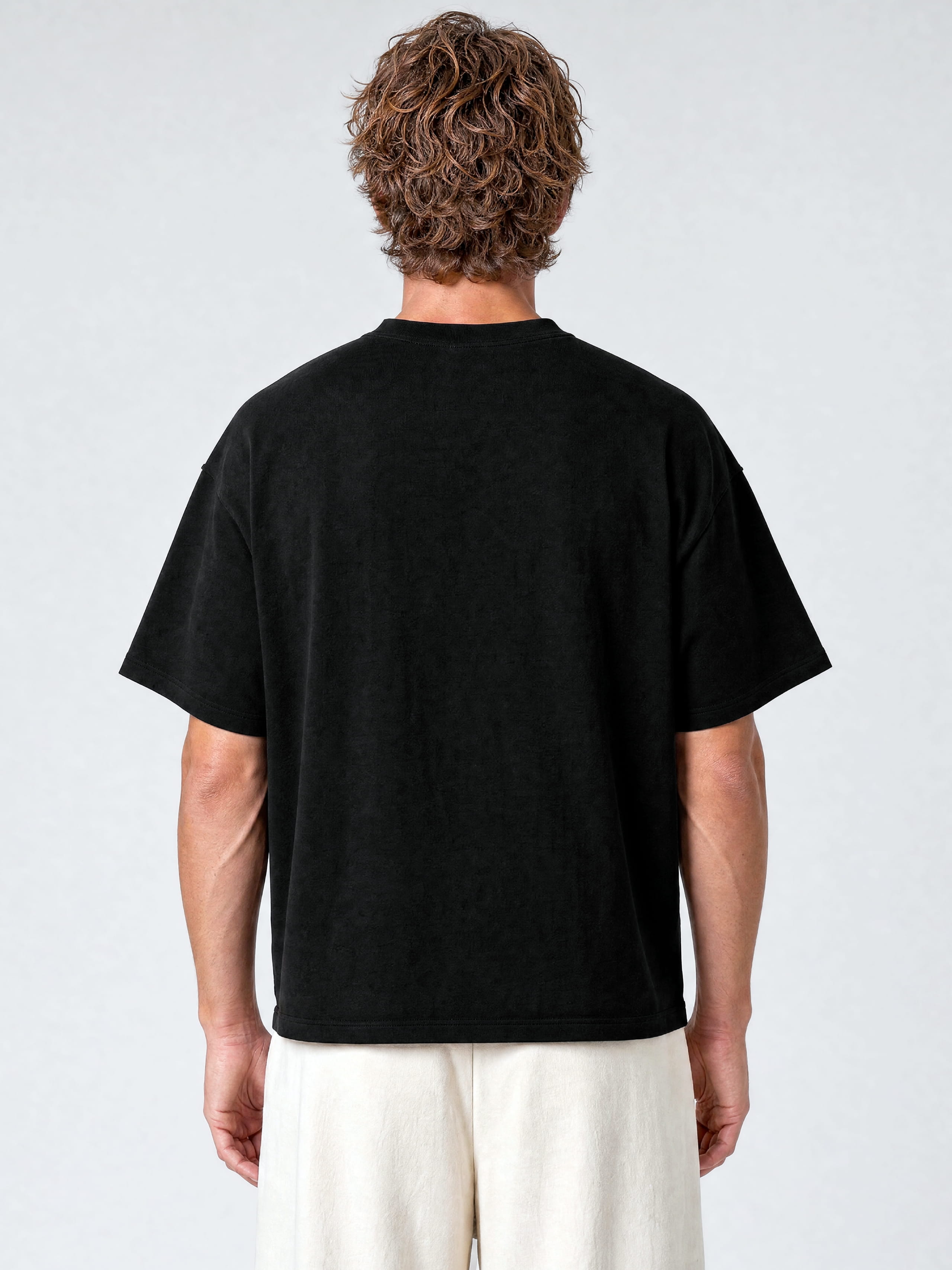 Black Monaco paneled shirt worn by model, back view showing oversized cut and drop shoulders.