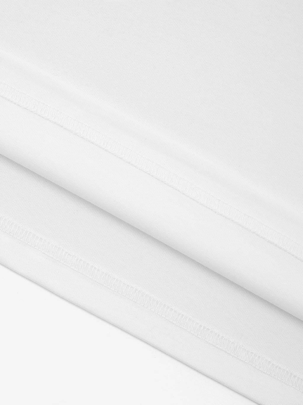 White Monaco 100% cotton paneled shirt close-up showing fabric texture and interior seam stitching.