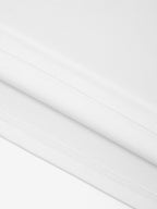 White Monaco 100% cotton paneled shirt close-up showing fabric texture and interior seam stitching.