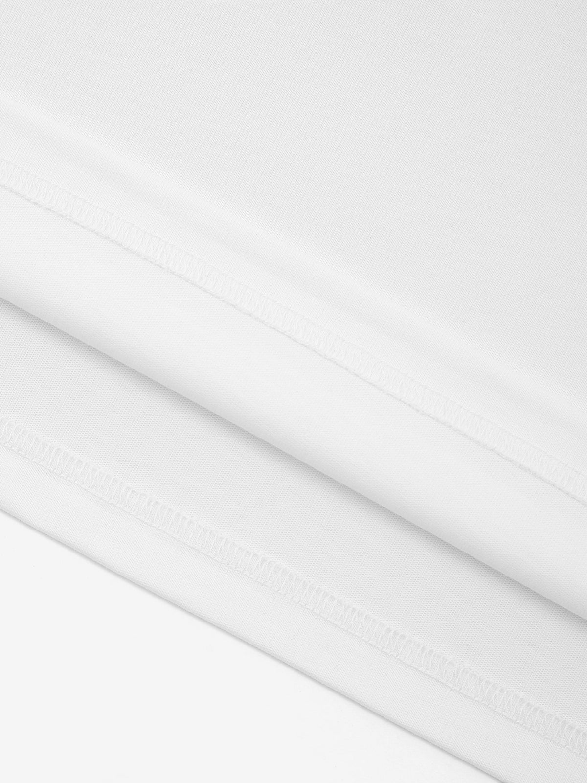 White Monaco 100% cotton paneled shirt close-up showing fabric texture and interior seam stitching.