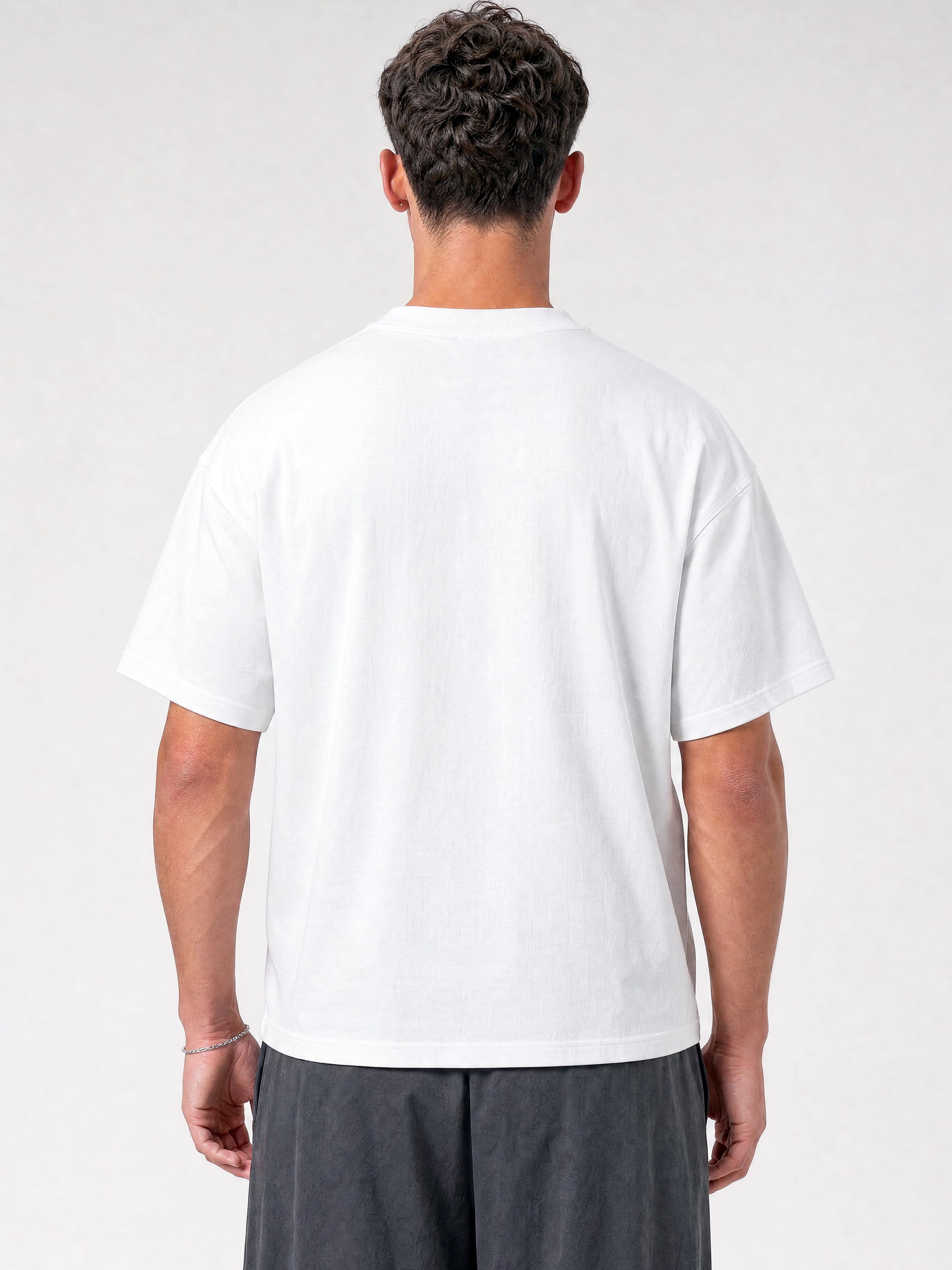 White Monaco paneled shirt worn by model, back view showing oversized cut and structured shoulders.